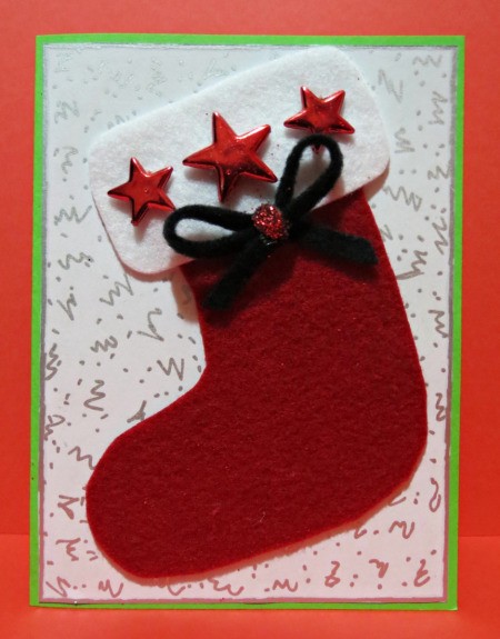 finished card with stars, bow, and glitter