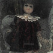 A Dandee porcelain doll in a box.