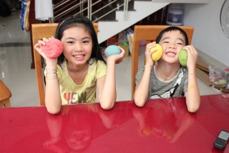 children holding balls of dough