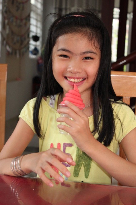 smiling girl with dough twist