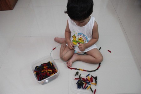 stringing colored pasta