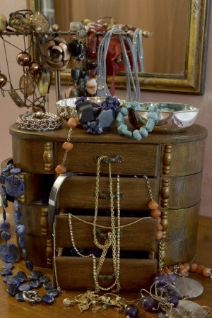 jewelry box with drawers overflowing with jewelry