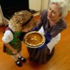 grandmother and child with pumpkin pie hot from the oven