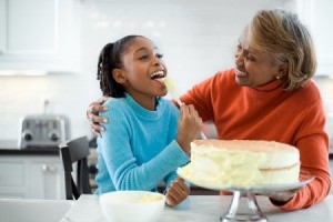 Grandmother and Granddaughter Icing a Cake
