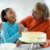 Grandmother and Granddaughter Icing a Cake