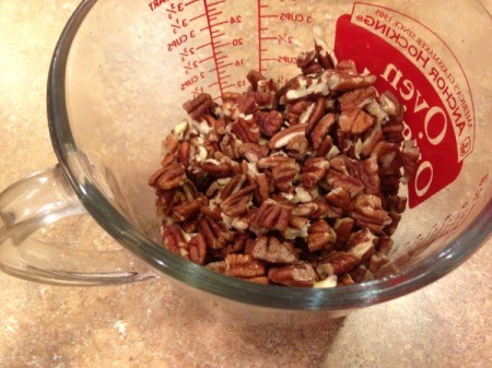 Southern Pecan Pie - broken pecans in measuring cup