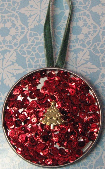 An ornament made from a juice can lid.