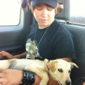 boy holding dog in car