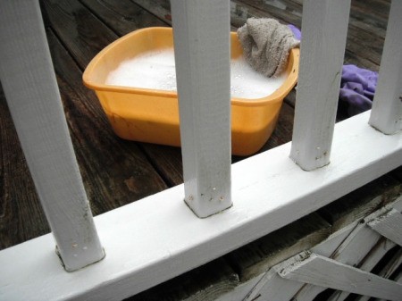 closeup of clean railing and pan of soapy water