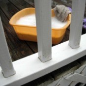 closeup of clean railing and pan of soapy water