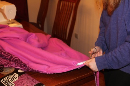 First Sewing Project: Fleece Blanket - trim off excess fabric from seam