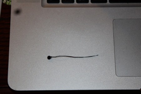 small black bead on thread