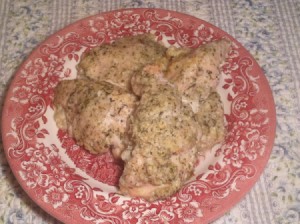 baked chicken on a red and white plate