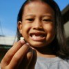 Girl Holding her Lost Tooth