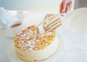cutting a slice of almond cake