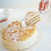 cutting a slice of almond cake