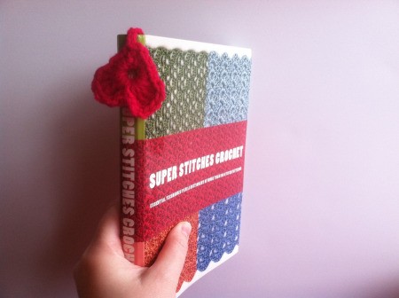 heart dangling with bookmark in book