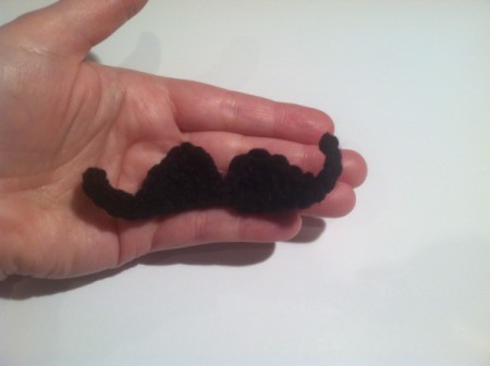 hand holding finished mustache