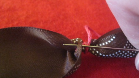 close to completed bead reinsert needle to inside of ribbon