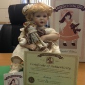 blonde doll holding a rag doll