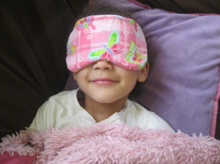 little girl wearing sleep mask