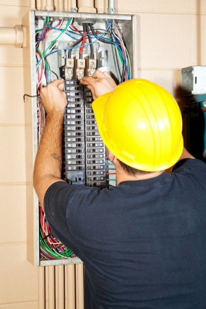 electrician working on breaker box