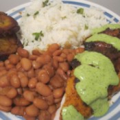 A dinner plate with roast chicken with aji sauce