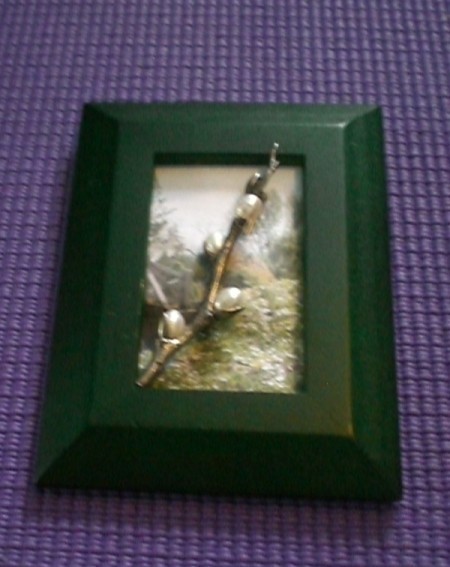 A green frame with a branch pin.