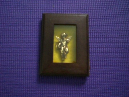 An angel pin inside a frame.