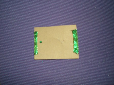 A pin and back ready to be placed in the frame.