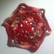 A completed crocheted flowering dishcloth.