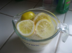 Lemon and Baking Soda for Cleaning Microwave - A measuring cup with lemons and baking soda.
