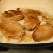 A pan of smothered pork chops.