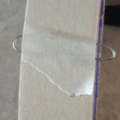 Paper clip holding tape end.