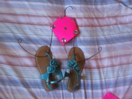 A finished recycled hanger flip flop holder.