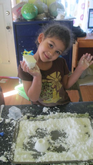little girl with a ball of the dough