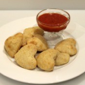 heart shaped calzones on plate with sauce for dipping