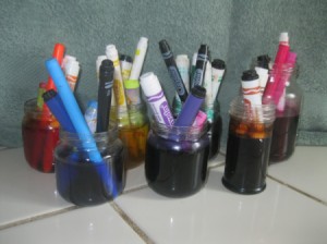 jars with markers soaking in water