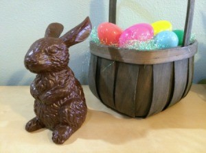 bunny sitting next to basket with plastic Easter eggs