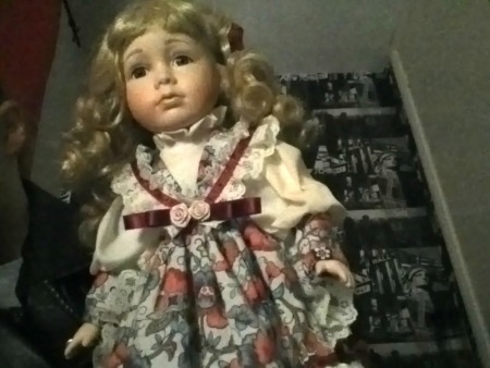 doll wearing dress with large green bow