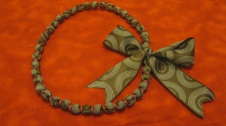 ribbon covered necklace with large bow