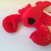 red stuffed lobster toy with an eye patch