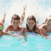 four children in a swimming pool