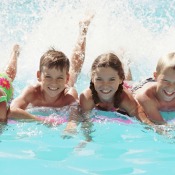 four children in a swimming pool