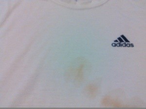 white shirt with stains and a colored logo