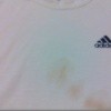 white shirt with stains and a colored logo