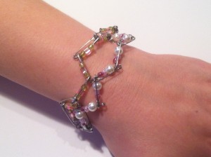 Safety pin bracelet being worn on wrist.