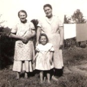An old fashioned black and white photo of a family.