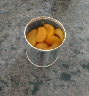 A can of mandarin oranges that has gone bad