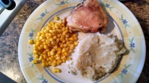 plate with corn, chop, and mashed potatoes